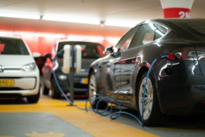 Electric vehicle on charge in car park