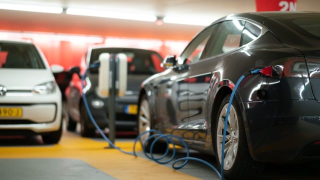 Electric vehicle on charge in car park